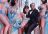 Photo of actor Gene Kelly with Tropicana Showgirls