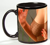 Photo of nearly bare breasts on a black coffee mug