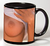 Photo of bare breasts on a black coffee mug