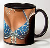 Photo of breasts in a rhinestone showgirl top reproduced on a black coffee mug
