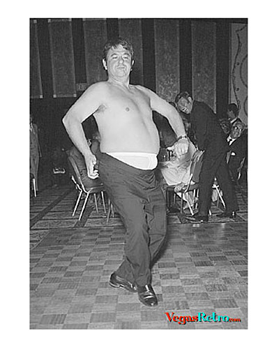 Photo of Buddy Hackett without his shirt dancing at a Frank Sinatra party